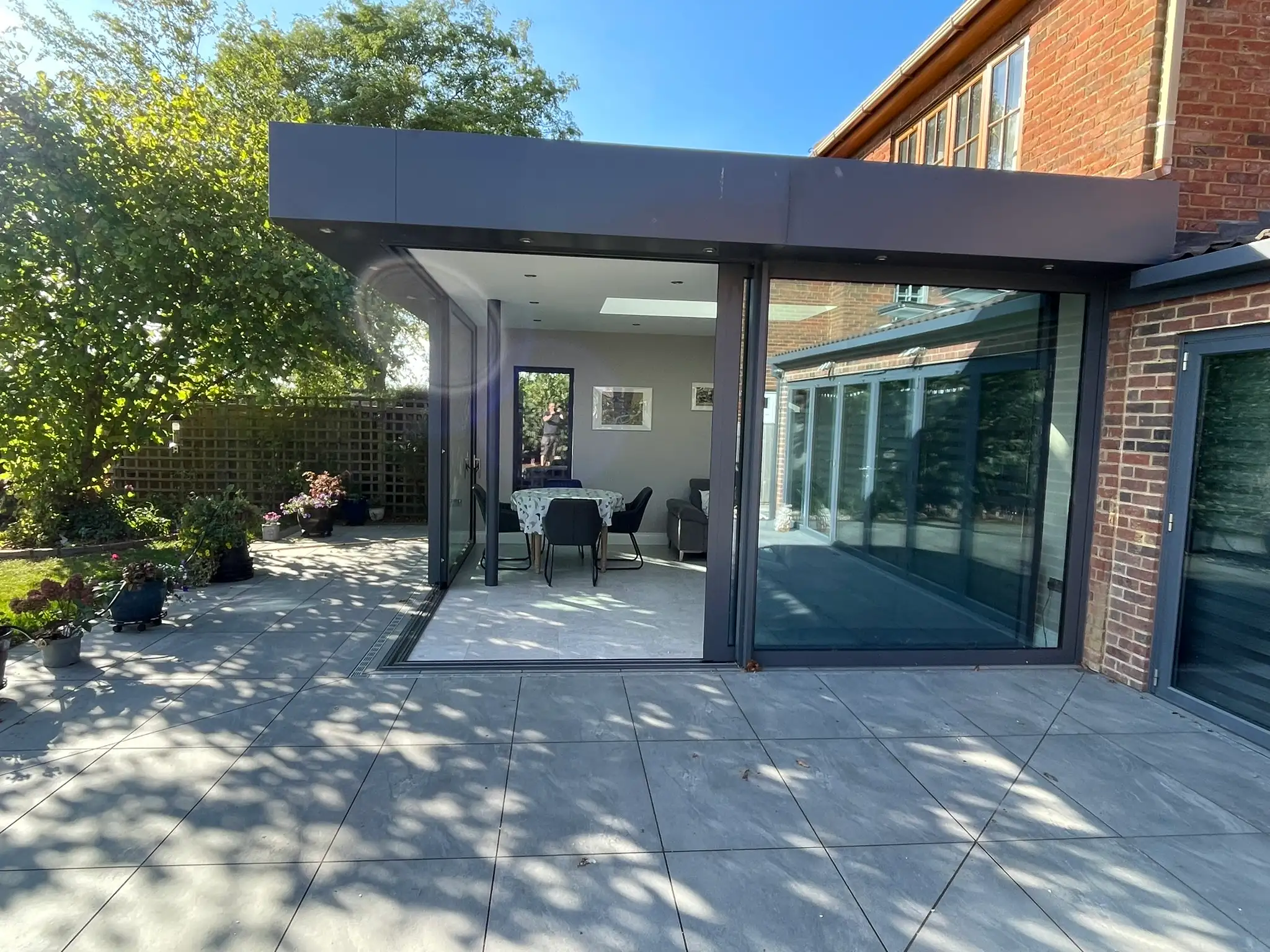 Large porcelain patio outside a glazed extension